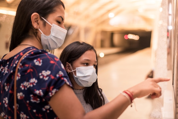 Mother and daughter wearing face mask