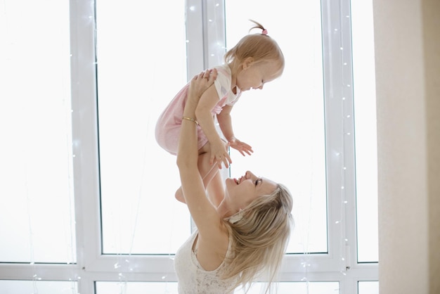 Mother and daughter in white with Christmas lights