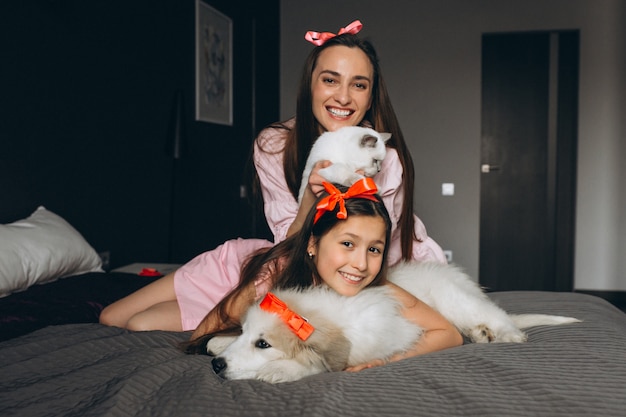 Mother and daughter with dog and kitten