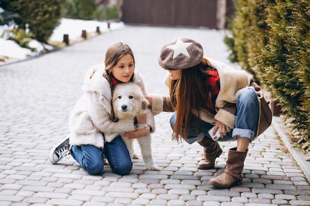 Mother and daughter with dog outside