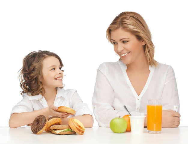 mother and daughter with healthy and unhealthy food