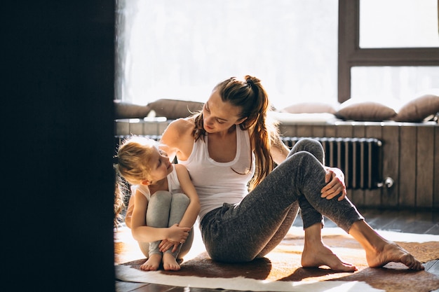 Mother and daughter yoga at home