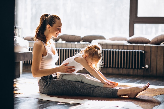 Mother and daughter yoga at home