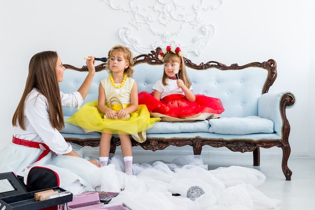 Mother and daughters doing makeup