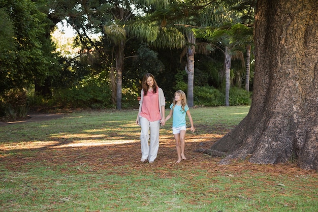 Mother and daugther walking in a park