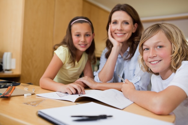 Mother doing homework with children