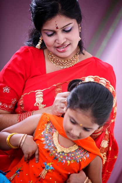 Mother dressing up daughter