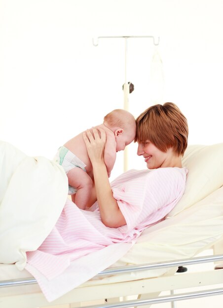 Photo mother embracing her newborn baby