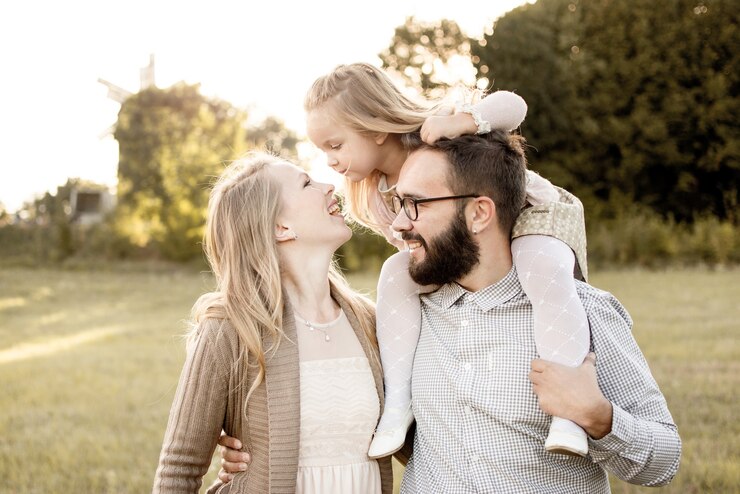 mother, father and child around dad's neck for a walk