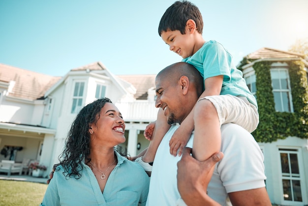 Mother father and child happy outdoor as family in backyard of house with a smile love and care Man woman and boy kid with parents for fun playing and quality time together for happiness