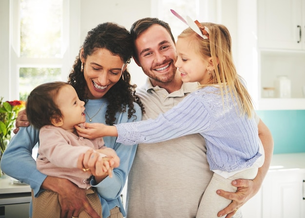 Mother father and children portrait in a happy family home while together for love support and care Woman man or parents with girl kids playing in a house for quality time bonding and to relax