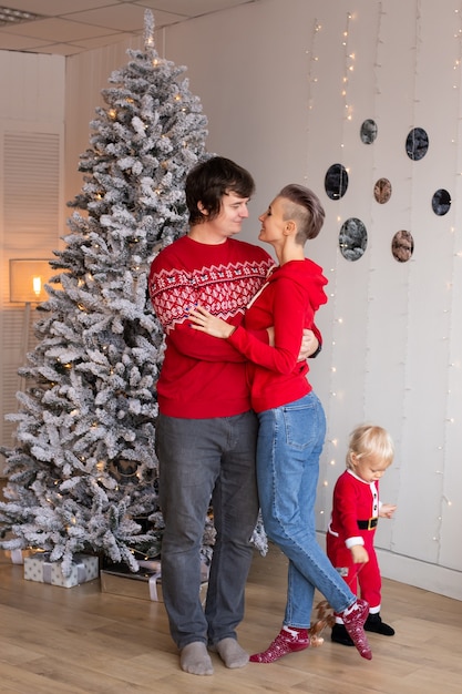 Mother and father in love celebrating winter holidays with their son child