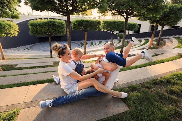 Mother and father playing in the park with their children