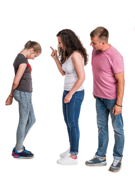 Mother and father shouting at teenage daughter on a white wall