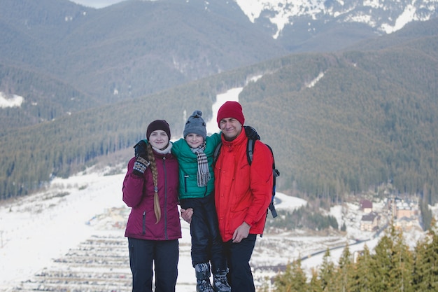 Mother, father and son are standing and smiling