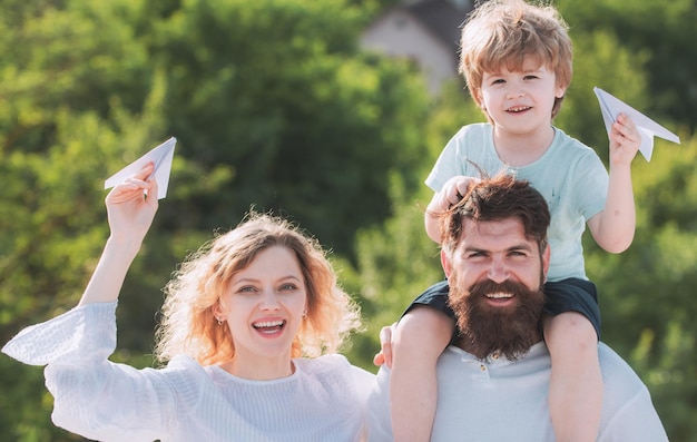 Mother father and son garden party in america happy family smiling and hugging cute little boy is ho