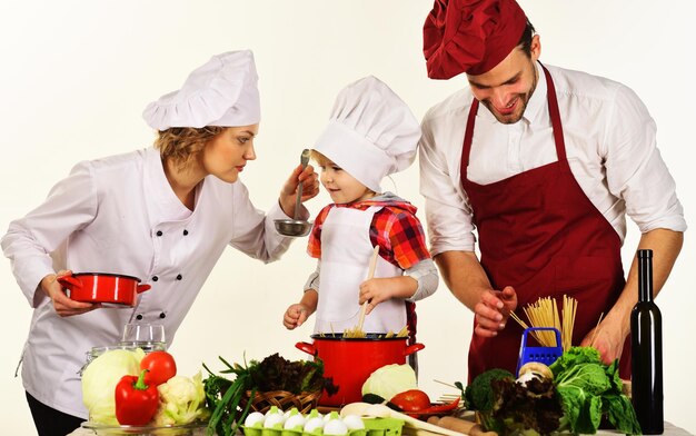 Mother father and son preparing tasty food at kitchen family cooking together healthy meal