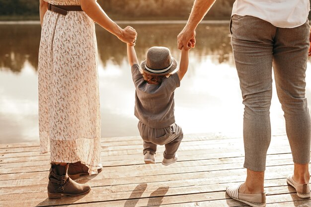 mother and father swinging kid