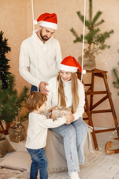 Mother father and their son celebrating Christmas together at home