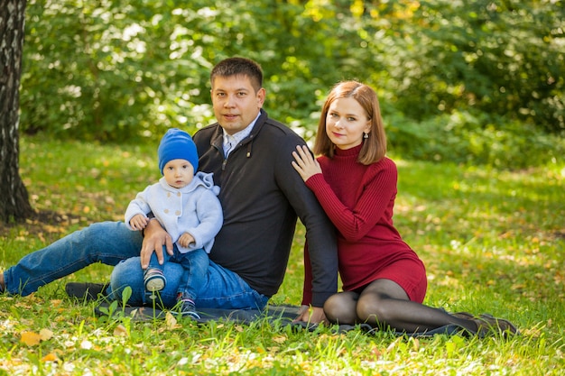 Mother, father, and their son on a walk in the park