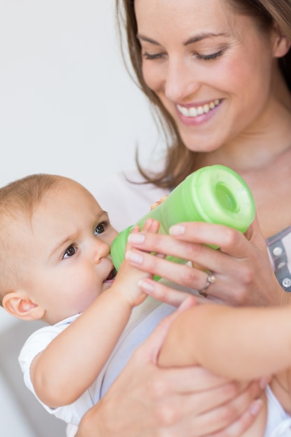 Mother feeding baby with milk bottle