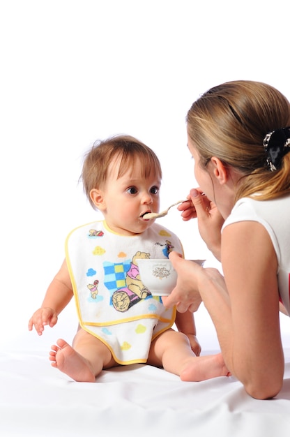 Mother feeding her little girl