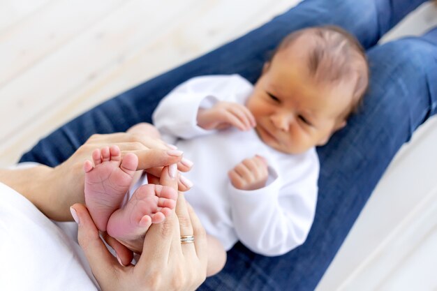 Photo mother feeds newborn baby from a bottle