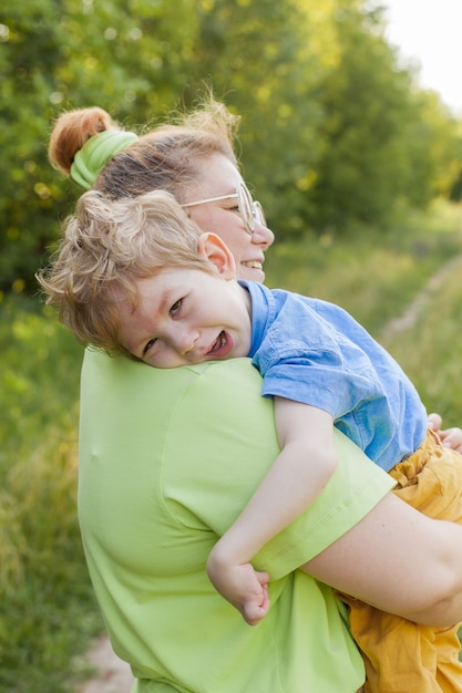 A mother gently hugs a disabled child. Infantile cerebral palsy. Enabling. Disability. A family with a disabled child.