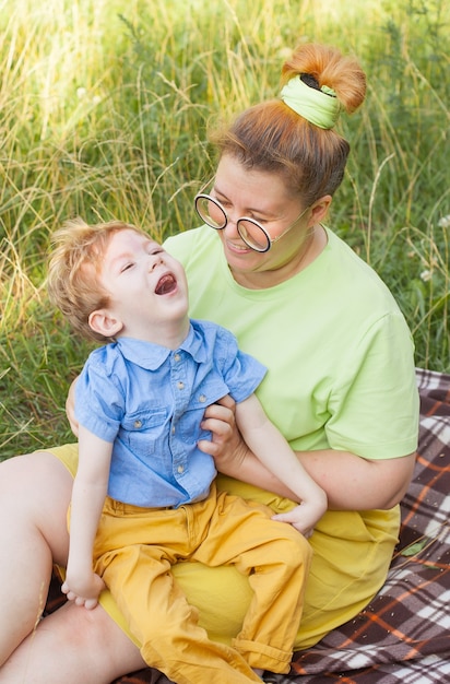 A mother gently hugs a disabled child. Infantile cerebral palsy. Enabling. Disability. A family with a disabled child.