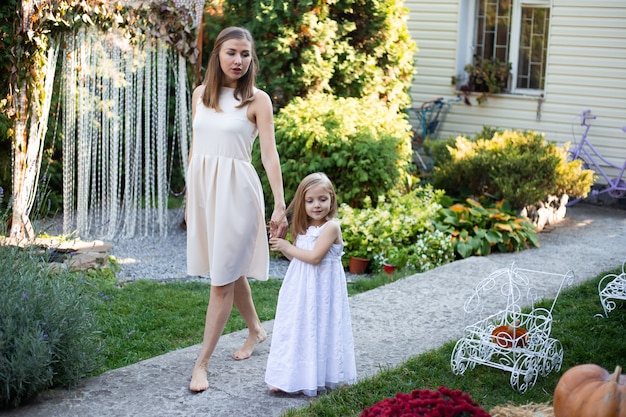 Mother and girl are walking outdoor in nature