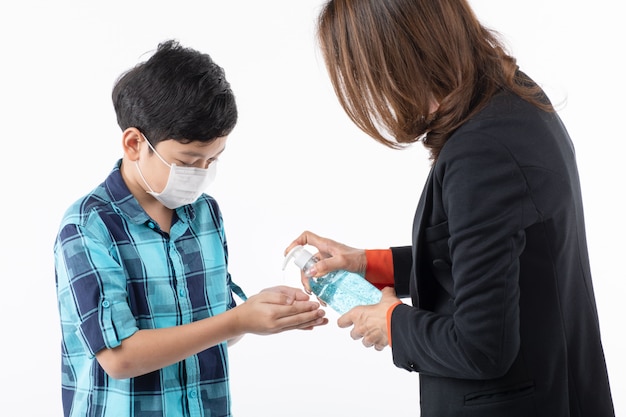 Mother give hand wash gel to son