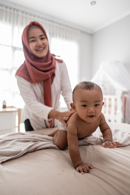 Mother giving a baby boy massage