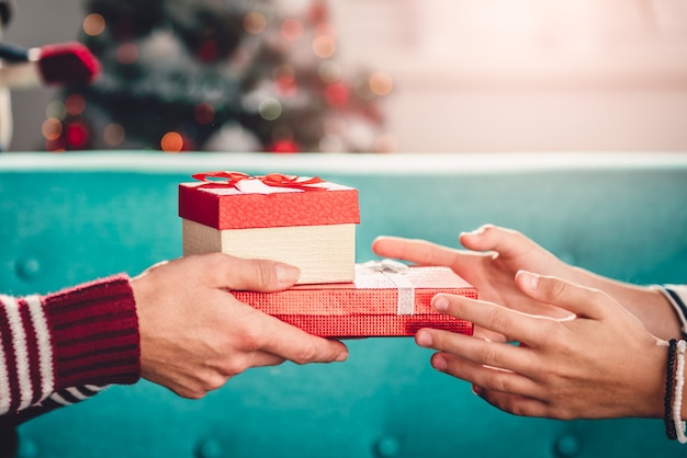 Mother giving christmas present to daughter