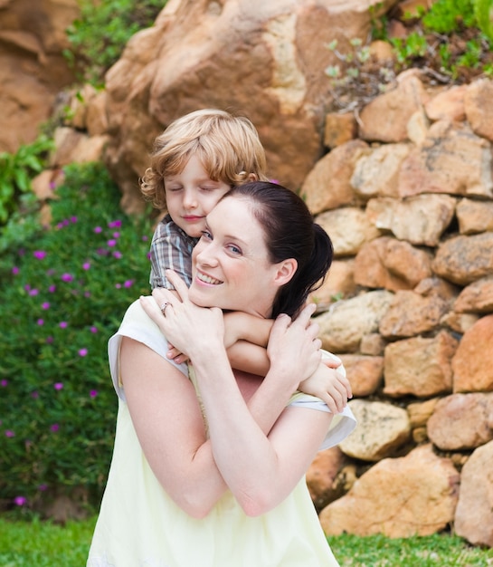 Mother giving son piggyback