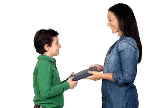 Mother handing a book to his son isolated on white background