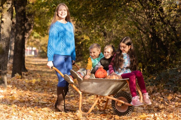 Mother have fun time with kids use garden wheelbarrow