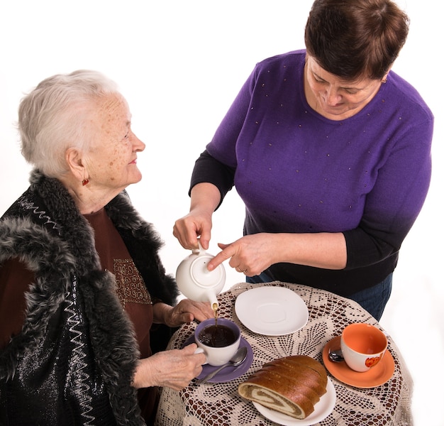 Mother having tea with her daughter