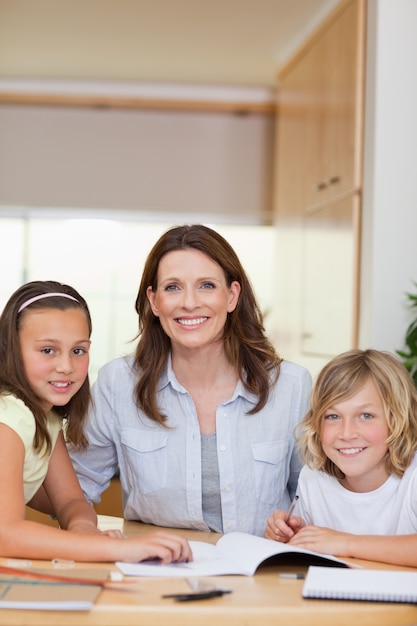 Mother helping children with homework