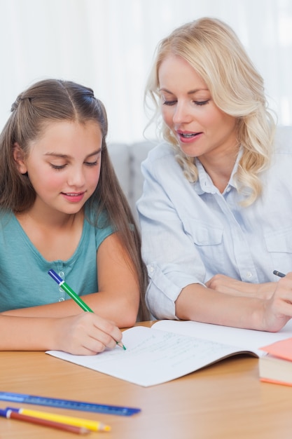 Mother helping daughter with homework