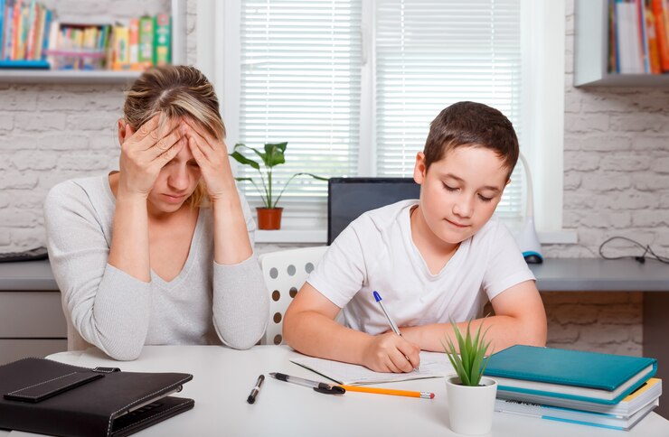 Mother helping her son at homework