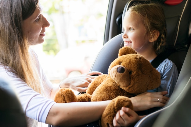 Mother helping to put on the seat belt