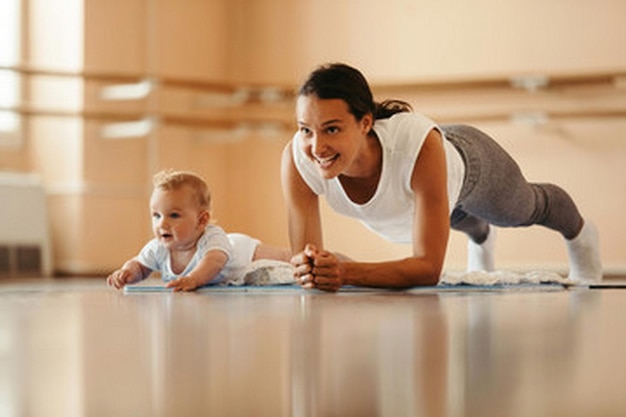 a mother and her baby are laying on the floor and the baby is laying on the floor