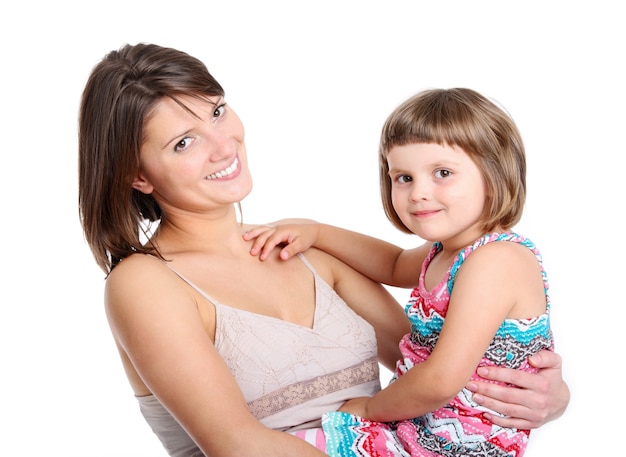 a mother and her baby girl smiling over white background