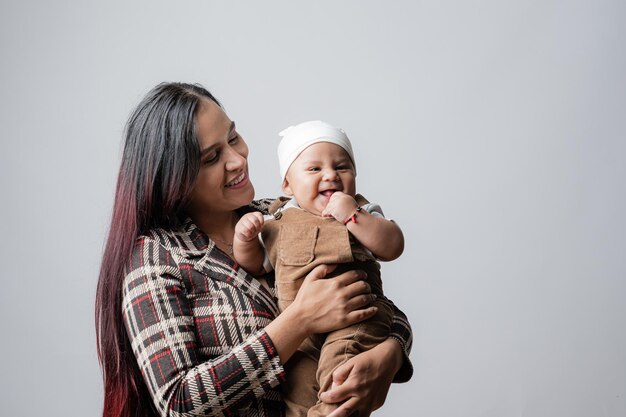 Mother and her baby very happy with her. Young mother holding her baby.