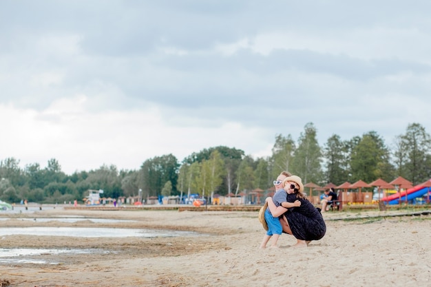 Mother and her cute little son enjoying time at beach