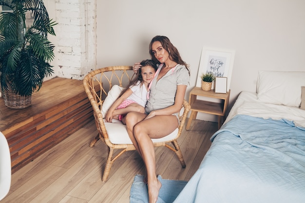 Mother and her cute preschool daughter in pajamas