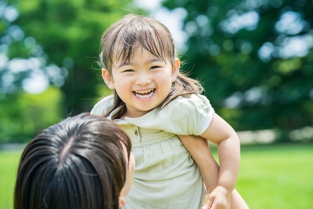 Mother and her daughter hugging in the park