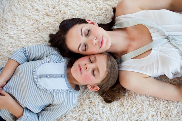 Madre e sua figlia che dormono sul pavimento