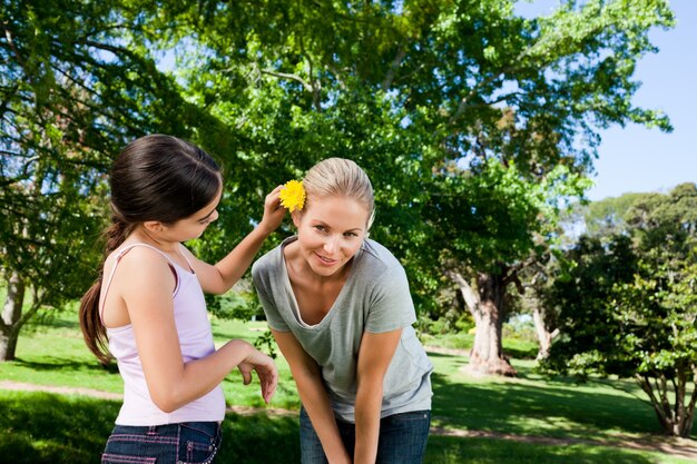 Mother and her daughter with a flower