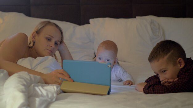 A mother and her kids having family time before bed